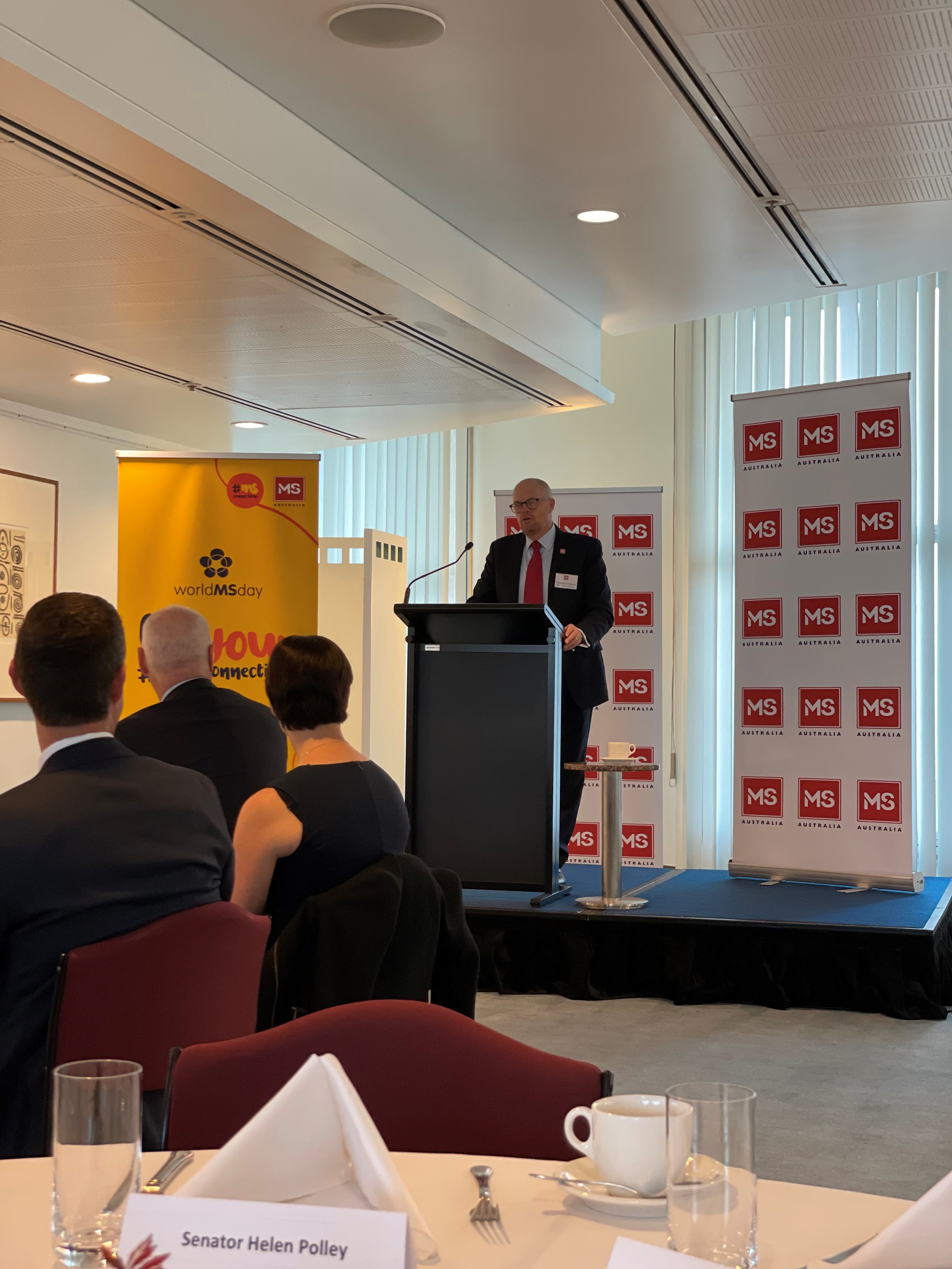 Des Graham, President of MS Australia speaks at the MS parliamentary friends breakfast